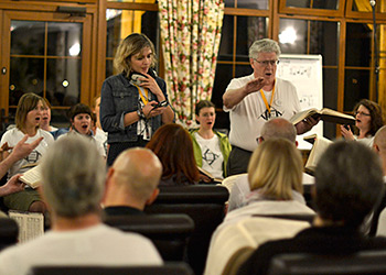 Camper and freelance journalist Kate Mossman records a song led by P. Dan Brittain at an evening singing for a short broadcast on the BBC World Service. Photograph by Ewan Paterson. Camper and freelance journalist Kate Mossman records a song led by P. Dan Brittain at an evening singing for a short broadcast on the BBC World Service. Photograph by Ewan Paterson.